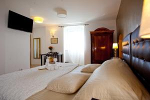 a bed with a stuffed animal sitting on top of it at Bed & Breakfast Vila Baguc in Split