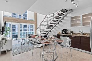 a kitchen and a living room with a spiral staircase at Elegant king bedroom Loft in Miami