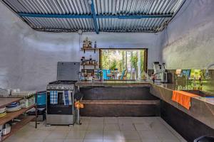 a kitchen with a counter and a stove in it at Uvita River Guesthouse in Uvita