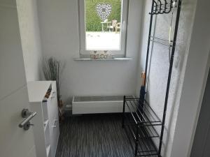 a bathroom with a window and a bench in a room at Alt Sammit in Alt Samitz