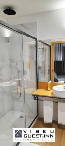 a bathroom with a shower and a sink at Viseu Guest Inn in Viseu