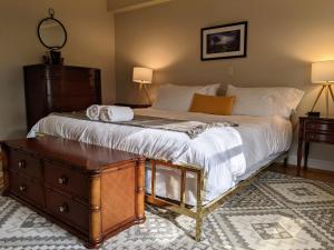 a bedroom with a large bed with a wooden dresser at Stanton House Inn in Greenwich