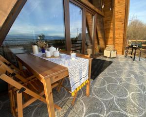 a wooden table on a patio with a view at Yaban Yasam Chalets in Yolcatı