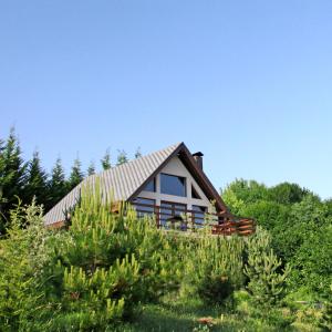 a house on a hill with trees and bushes at Yaban Yasam Chalets in Yolcatı