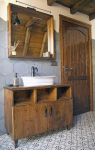 a bathroom with a sink and a wooden cabinet at Yaban Yasam Chalets in Yolcatı
