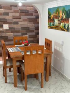 a dining room with a wooden table and chairs at Acogedor apartamento cerca al centro de Medellin in Medellín