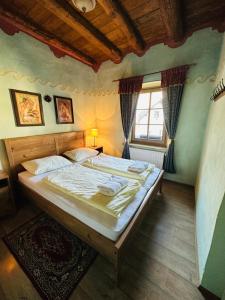 a bedroom with a large bed and a window at Apartments Belopeški Dvori in Kranjska Gora