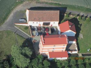 an aerial view of a house with cars parked in front at Penzion Hajský mlýn in Nebanice