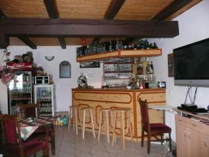 a bar in a restaurant with a table and chairs at Penzion Hajský mlýn in Nebanice