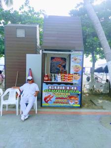 a man in a santa hat sitting in a chair in front of a small at Hugos studio loft in Gaira