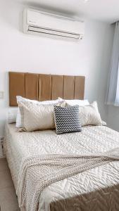 a bed with two pillows on it in a bedroom at Apartamento no coração do Rio in Rio de Janeiro