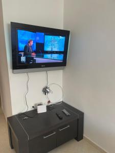a flat screen tv hanging on a wall at Economic Apartment Alhoceima WIFI in Al Hoceïma