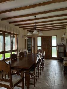a dining room with a wooden table and chairs at Cabo de Veiga in Trabada