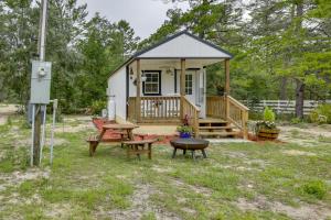 a small cabin with a picnic table and a bench at Pet-Friendly Gulf Coast Rental Near Keaton Beach! in Perry