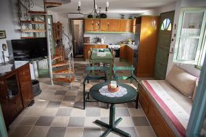 a kitchen with a table and chairs in a room at Kos Gaia Garden House 