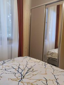 a bedroom with a bed and a mirror at Коттедж у моря in Batumi +10 photos