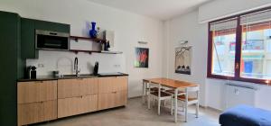 a kitchen with a table and a sink and a counter at Casa del Mare- Bluchalet in Rapallo +16 photos
