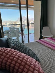 1 dormitorio con cama y vistas al agua en Apartamento Paraiso Lido, en Benidorm
