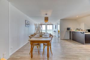 a kitchen and dining room with a table and chairs at Le Sunset Beach (les pieds dans l'eau) vue mer exceptionnelle in Fécamp