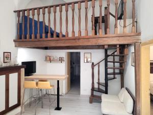 a room with a loft bed and a desk and a staircase at Visiale guest house in Spoleto