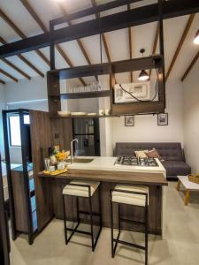 a kitchen with a counter with a sink and a stove at Casa García Rent Home in Guatapé