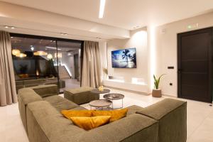 a living room with a couch and a table at STALèA Luxury Villa in Pefki Rhodes