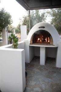 a pizza oven with a fire inside of it at Kos Gaia Garden House 
