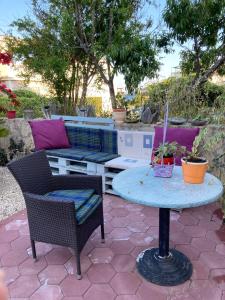 a patio with a table and two chairs and a table with at Apartment s Jukica in Vis