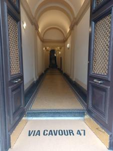 a hallway in a building with a sign on the floor at Hotel Leone in Rome