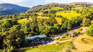 an aerial view of a farm house in the hills at MotoCamp Wales -Camping Pods in Dolgellau