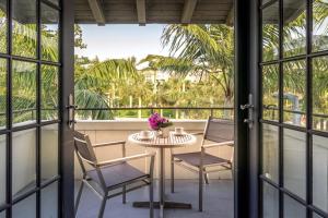 a patio with a table and chairs on a balcony at Bungalows at The Boca Raton in Boca Raton