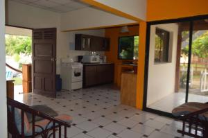 uma cozinha com uma porta aberta e cadeiras em MALIBU HOUSE 