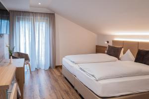 Voodi või voodid majutusasutuse Garni Hotel Am Meilenstein toas