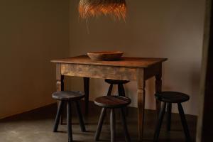 a wooden table with two stools and a bowl on top at SOLO PALACIO - Boutique Hotel & Spa 