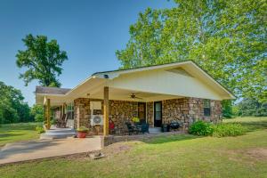 a stone house with a porch and a patio at Delaware Vacation Rental Walk to Lake Dardanelle! 