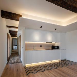 a kitchen with white cabinets and a counter top at El Jardinillo del Salvador in Cuenca