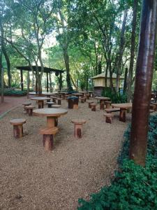 een groep picknicktafels en banken in een park bij Apart Flat Aguas da Serra in Rio Quente
