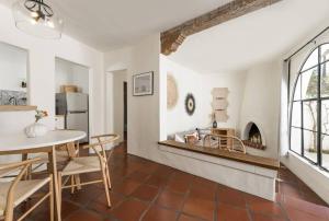 a kitchen and dining room with a table and chairs at 1 Bedroom Casita - Casa Blanca in Montecito