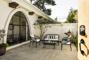 a patio with two chairs and a table at 1 Bedroom Casita - Casa Blanca in Montecito