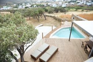 a deck with a swimming pool on top of a house at Villa Prasini in Agios Sostis