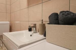 a bathroom with a sink and a toilet at Apartma Mimi in Izola +6 photos