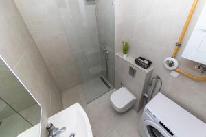 a bathroom with a shower and a toilet and a sink at LuSea Apartment in Zadar +25 photos