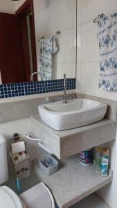 a bathroom with a sink and a toilet at Praia Grande, Canto do Forte, Apto ,2 noites seguidas , apenas 2 diárias com Wi-Fi in Praia Grande +18 photos