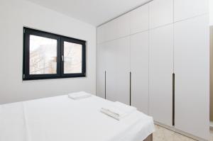 Ένα ή περισσότερα κρεβάτια σε δωμάτιο στο Lira Suites