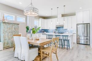a kitchen and dining room with a wooden table and chairs at Waterfront Wonderland in Rockport