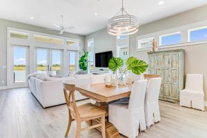 a dining room and living room with a table and chairs at Waterfront Wonderland in Rockport