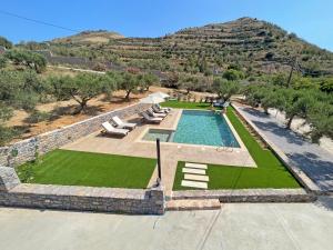 an aerial view of a swimming pool with a hill in the background at Drosia Villa Private Nature Getaway! in Plakias