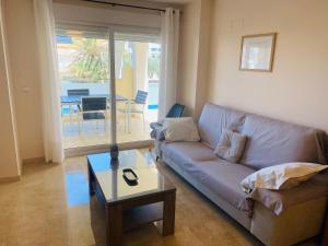 a living room with a couch and a table at Anacasa Vora Golf 3 Playa Rabdells DUP3027 in Oliva