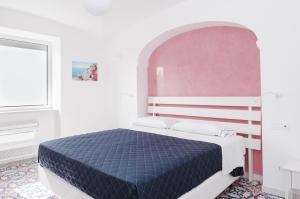 sypialnia z łóżkiem w białym pokoju w obiekcie A Gradillo holiday rooms w mieście Ravello