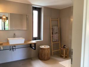 un bagno con lavandino e specchio di Villa Tartaya a Dassia Altre 64 foto